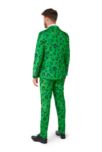 A man wearing the Suitmeister's "The Riddler" costume, featuring a bright green pattern with question marks, stands with his back to the camera. The ensemble includes both matching pants and a jacket. He has short brown hair and is sporting black shoes.