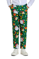 A person is dressed in the festive Santa Elves Green Christmas suit by Suitmeister, featuring Santa Claus, gifts, stars, and snowflakes designs. They accompany it with a white shirt and white sneakers.