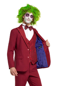 A person dressed in the Beetlejuice Groom costume by Suitmeister, featuring bright green hair and clown-like face paint. They wear a red suit with a vest and polka dot bow tie and display the blue lining of the jacket.