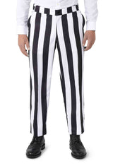 A person dressed in the Suitmeister Beetlejuice costume, featuring black and white vertically striped pants and a white shirt, stands facing forward while paired with black shoes.