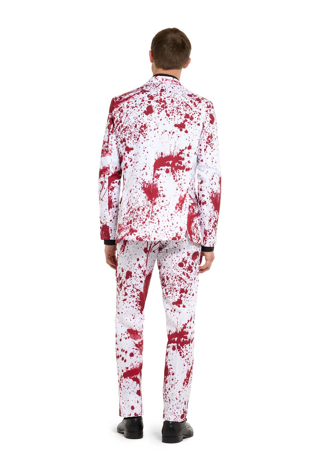 A person dressed in a "Bloody Suit White - Halloween suit" by Suitmeister, featuring a jacket and pants with red splatter patterns, stands facing away. The ensemble is paired with black shoes against a plain white background.