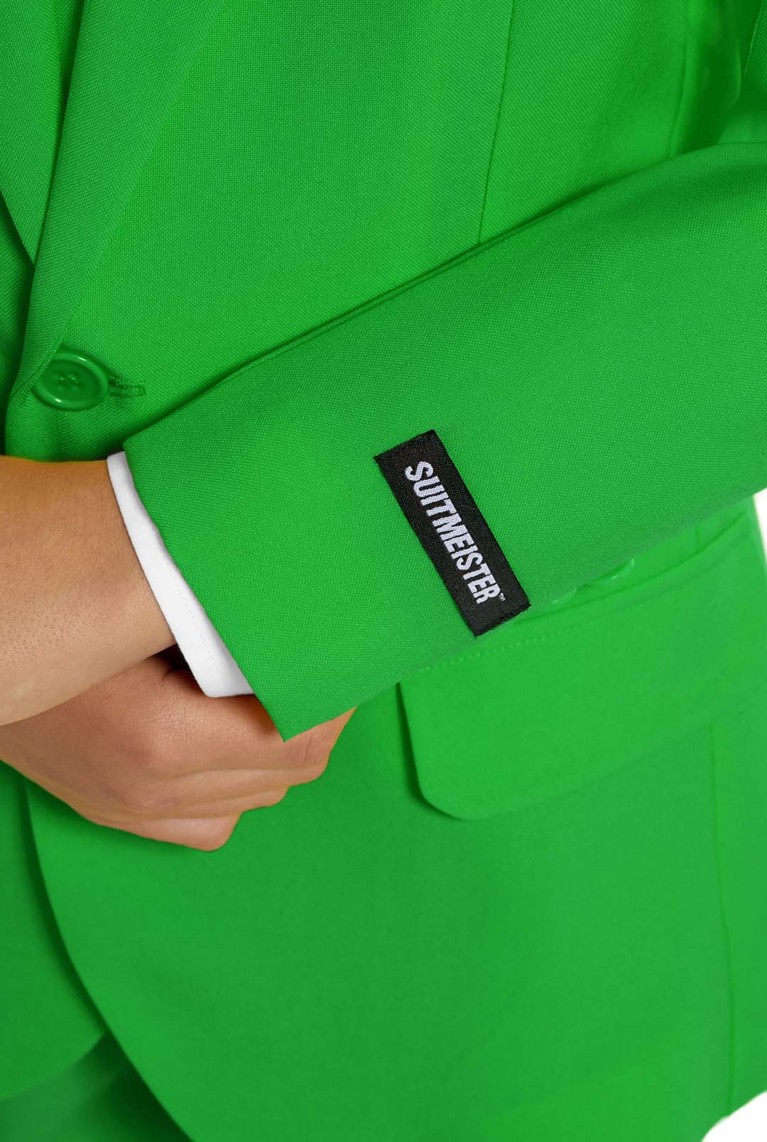 Close-up of a person in a Solid Green - Green suit by Suitmeister, with a white shirt cuff visible. Theyre holding their other hand near their waist.