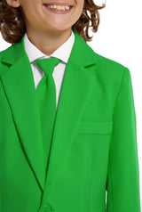 A child smiles while wearing Suitmeisters Solid Green suit, featuring a bright green color with a matching tie over a white shirt, capturing the vibrant essence of the outfit.