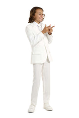 A young person with curly hair is wearing the Solid White suit by Suitmeister and sneakers. They are playfully posing, pointing both hands to the side while smiling against a plain white background.