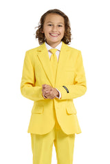 A child with a joyful expression and curly hair is wearing the Solid Yellow suit by Suitmeister, complete with a matching tie, set against a white background.