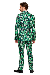 A man wearing Suitmeister’s Cannabis suit, featuring a cannabis leaf pattern, stands facing away and is complemented by black shoes.