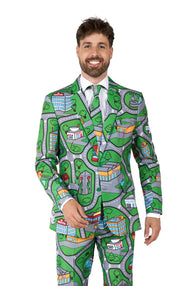 A man smiling and dressed in the Suitmeister's "Carpet City Green - Play Carpet" suit, which showcases a vibrant, cartoon-inspired city map design with roads, buildings, and trees. He stands against a simple white backdrop.