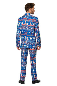 A man is wearing the Christmas Suit Blue Nordic by Suitmeister, featuring vibrant blue with festive patterns like snowflakes, Christmas trees, and reindeer. He stands facing away, highlighting the back of the suit.