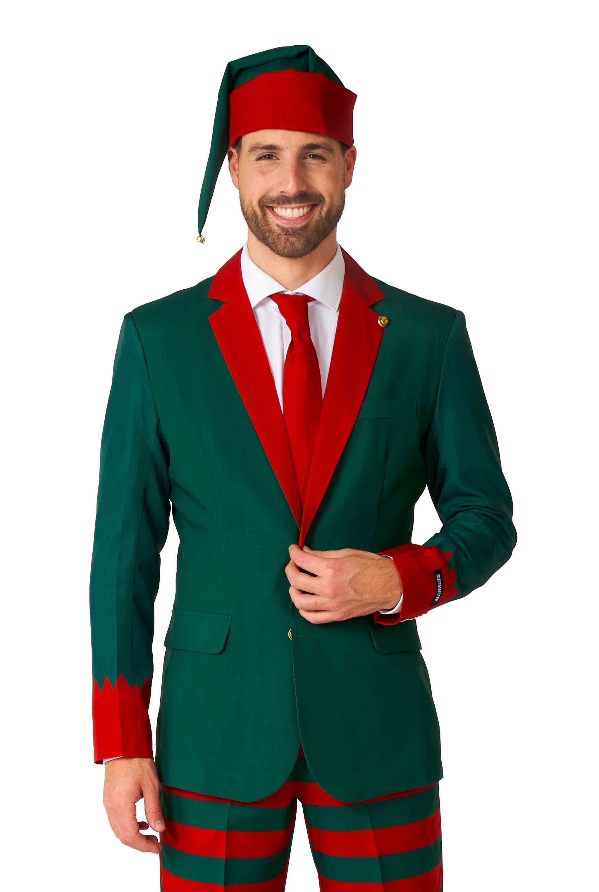 A person dressed confidently in Suitmeister's Santa's Elf Green - Christmas Elf Suit, complete with a matching hat. This playful holiday ensemble features a red tie and red-striped pants for the perfect festive look.