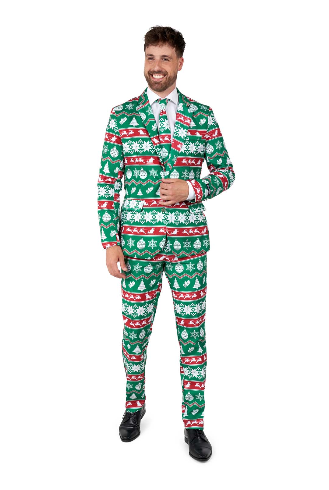 A man wearing the Suitmeister "Christmas Green Nordic" suit features festive green with white and red Christmas-themed patterns, including snowflakes and trees. He stands smiling with one hand holding the lapel and the other by his side, complemented by a white shirt, tie, and black shoes.