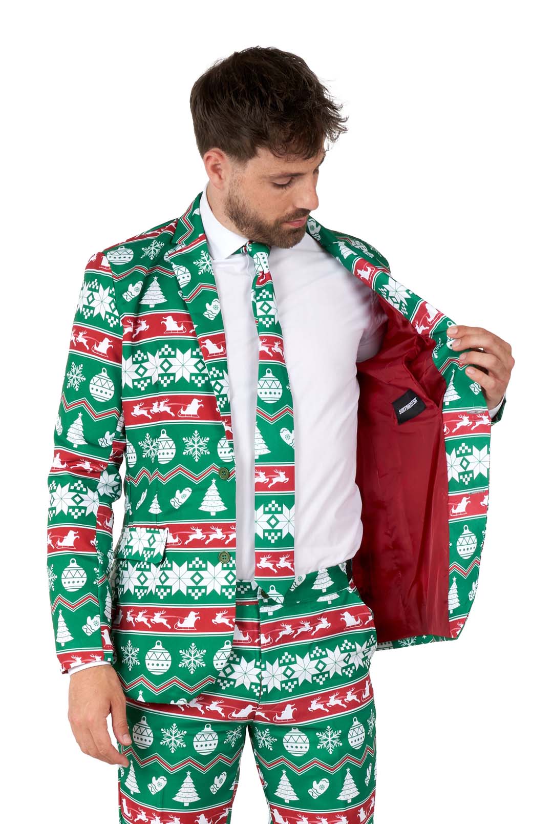 A man is wearing the Suitmeister Christmas Green Nordic suit, featuring festive patterns like snowflakes and trees in green, red, and white. He opens the jacket to reveal its red lining.