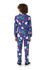 A child is seen from behind wearing the Suitmeister Christmas Snowman Blue, a festive ensemble featuring matching pants and jacket adorned with snowmen, Christmas trees, and candy canes. The look is completed with black sneakers that have white soles.