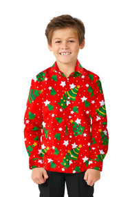 A smiling child wearing the "Suitmeister Christmas Trees Stars Red" shirt, featuring festive Christmas tree and star patterns, stands against a plain white background. This button-up Christmas shirt adds a joyful touch to the scene.