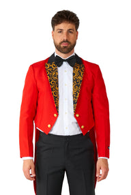 A man is dressed in the Suitmeister Circus Tailcoat Suit Red, featuring a striking red tailcoat with a black and gold patterned lapel. He stands facing forward and complements his look with a white shirt, black bow tie, and black pants against a plain white background.