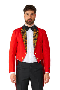 A man is dressed in the Suitmeister Circus Tailcoat Suit Red, featuring a striking red tailcoat with a black and gold patterned lapel. He stands facing forward and complements his look with a white shirt, black bow tie, and black pants against a plain white background.