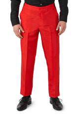 A person dressed in the Devil Red - Halloween suit by Suitmeister, featuring vibrant red dress pants with a sharp crease down the front, paired with a black long-sleeve shirt. They stand with their arms at their sides and complete the look with black dress shoes.