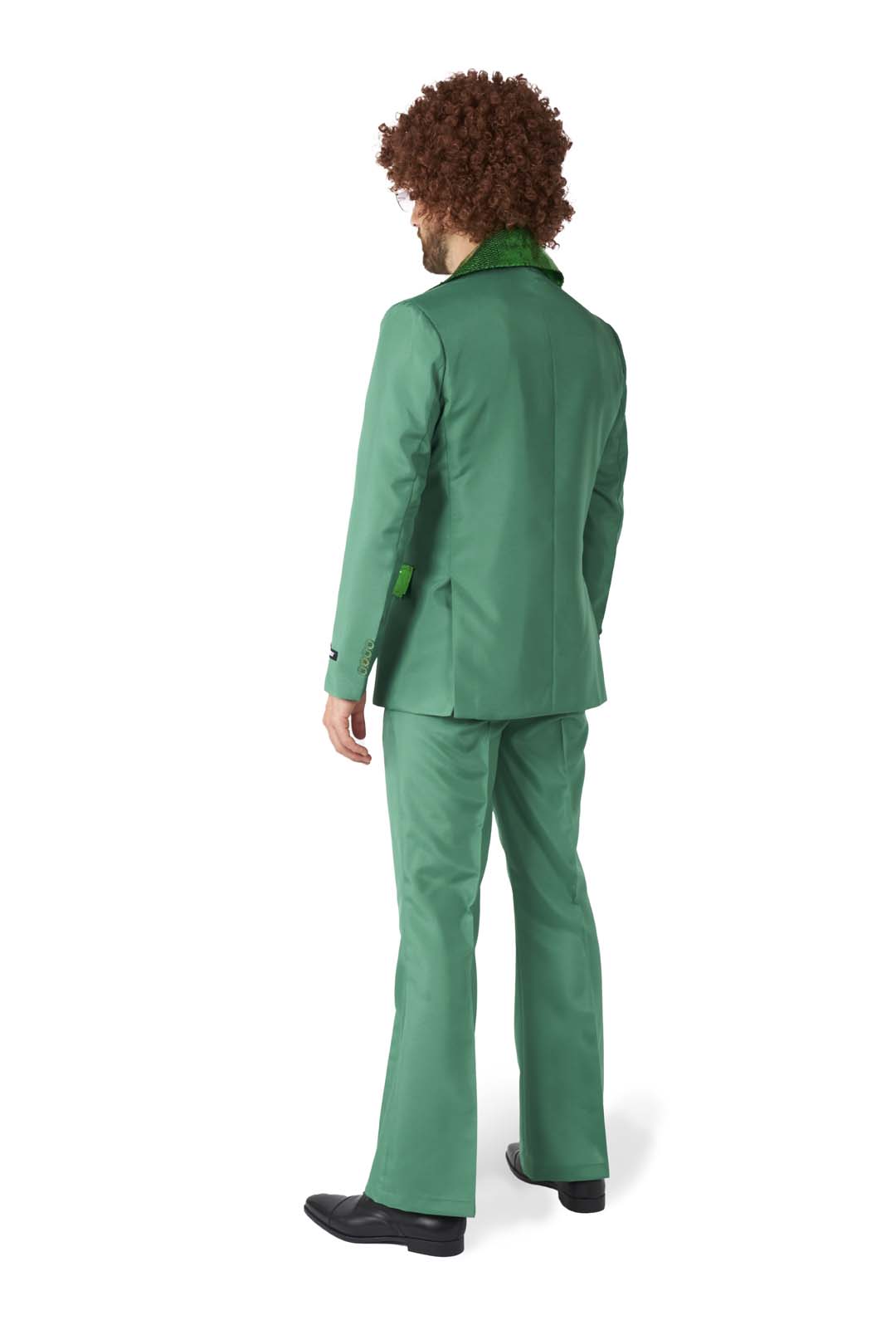 A person with curly hair is seen standing and facing away from the camera, dressed in the Suitmeister's Disco Suit Green, featuring a fuzzy collar and flared pants, paired with black shoes. The backdrop is plain white.