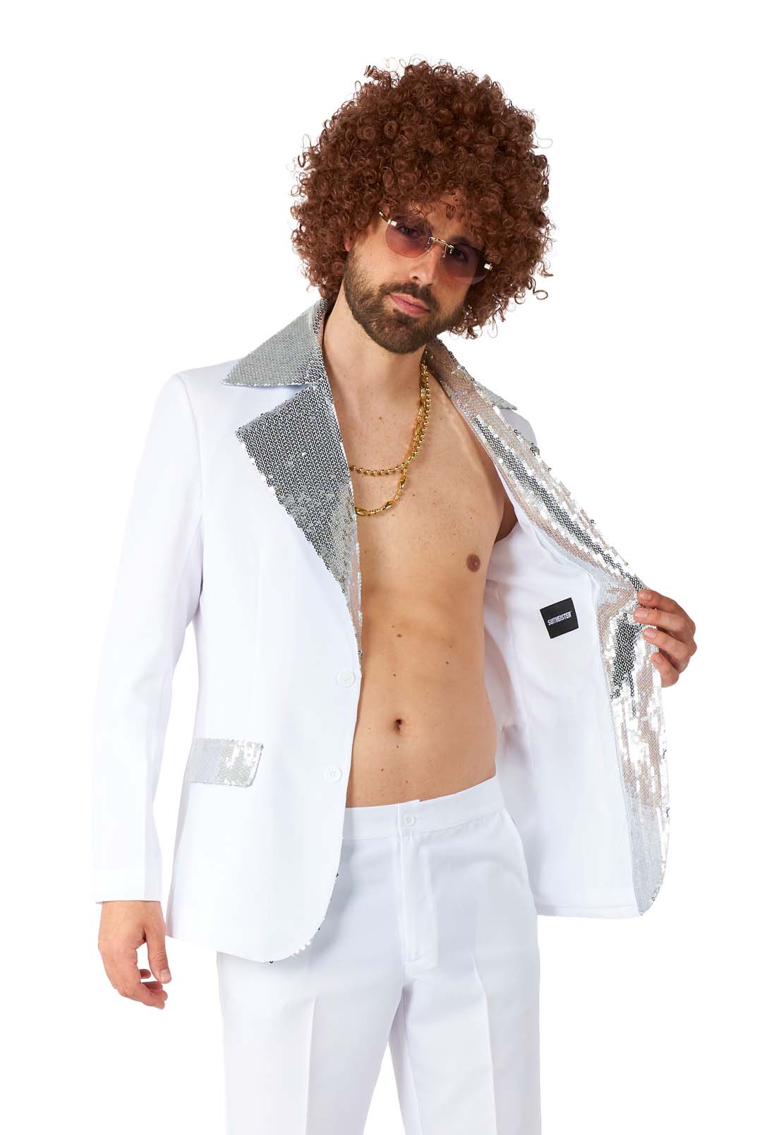 A person with curly hair wearing sunglasses and Suitmeister's Disco Suit White, featuring a sequined lapel. The suit jacket is open, revealing a bare chest adorned with a gold chain necklace. The person's expression exudes relaxation and confidence.