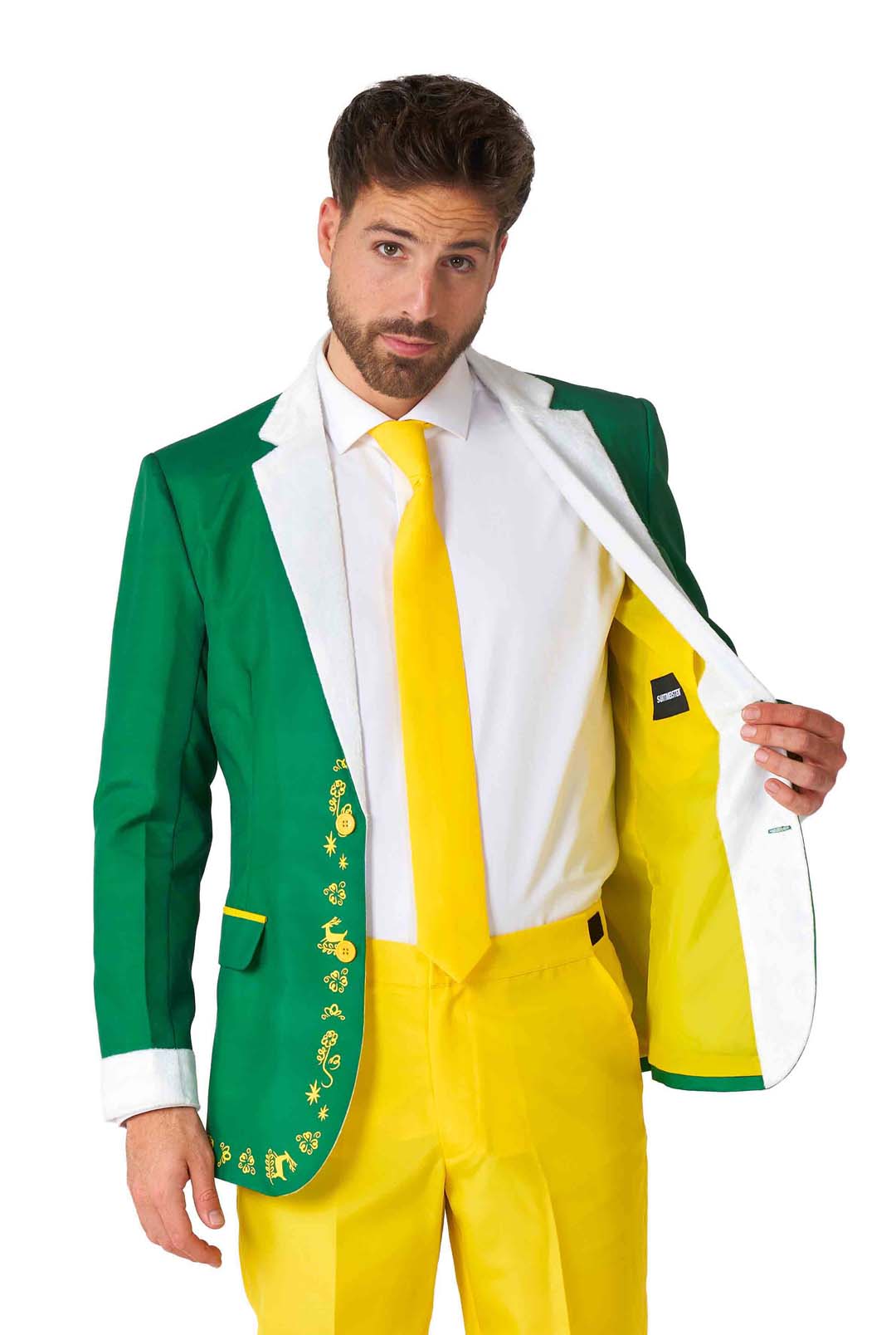 A man is wearing the Elf™ Christmas Suit by Suitmeister, featuring playful designs on the jacket. The jacket is bright green with white lapels and cuffs, and he holds it open. The pants and tie are vivid yellow, all set against a white background.