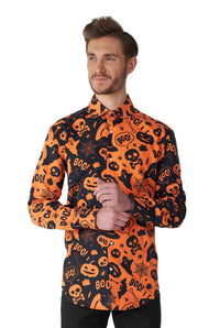 A man wearing the Suitmeister "Halloween Icons" shirt, featuring Halloween-themed patterns in orange and black with motifs like ghosts, skulls, pumpkins, and the word "Boo!" He has short hair and is looking to the side with a slight smile against a plain white background.