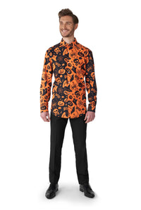 A person stands smiling, wearing the Suitmeister Halloween Icons shirt. The long-sleeved shirt features a Halloween theme with orange and black designs of bats, pumpkins, and the word "BOO!" It is paired with black pants and shoes.