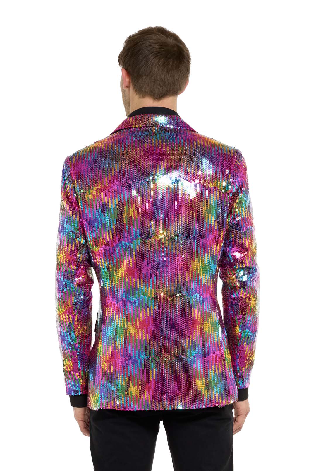 A person faces away from the camera in a Rainbow Sequin Blazer by Suitmeister, featuring a vibrant pattern. They have short hair, wear black pants, and stand against a plain white background.