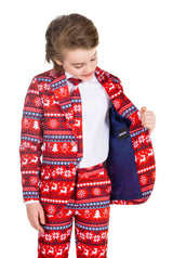 A child dressed in the Suitmeister's Nordic Pixel Red - Christmas suit, featuring a festive red and white pattern with winter motifs like snowflakes and Christmas trees, looks down while opening the jacket to reveal its inner lining. The child, who has light brown hair, is standing against a plain background.