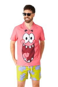 A man dressed in a Suitmeister Patrick costume, featuring sunglasses and a pink shirt adorned with a cartoon face, is smiling. He is also wearing bright green shorts with distinctive purple cloud-like patterns.