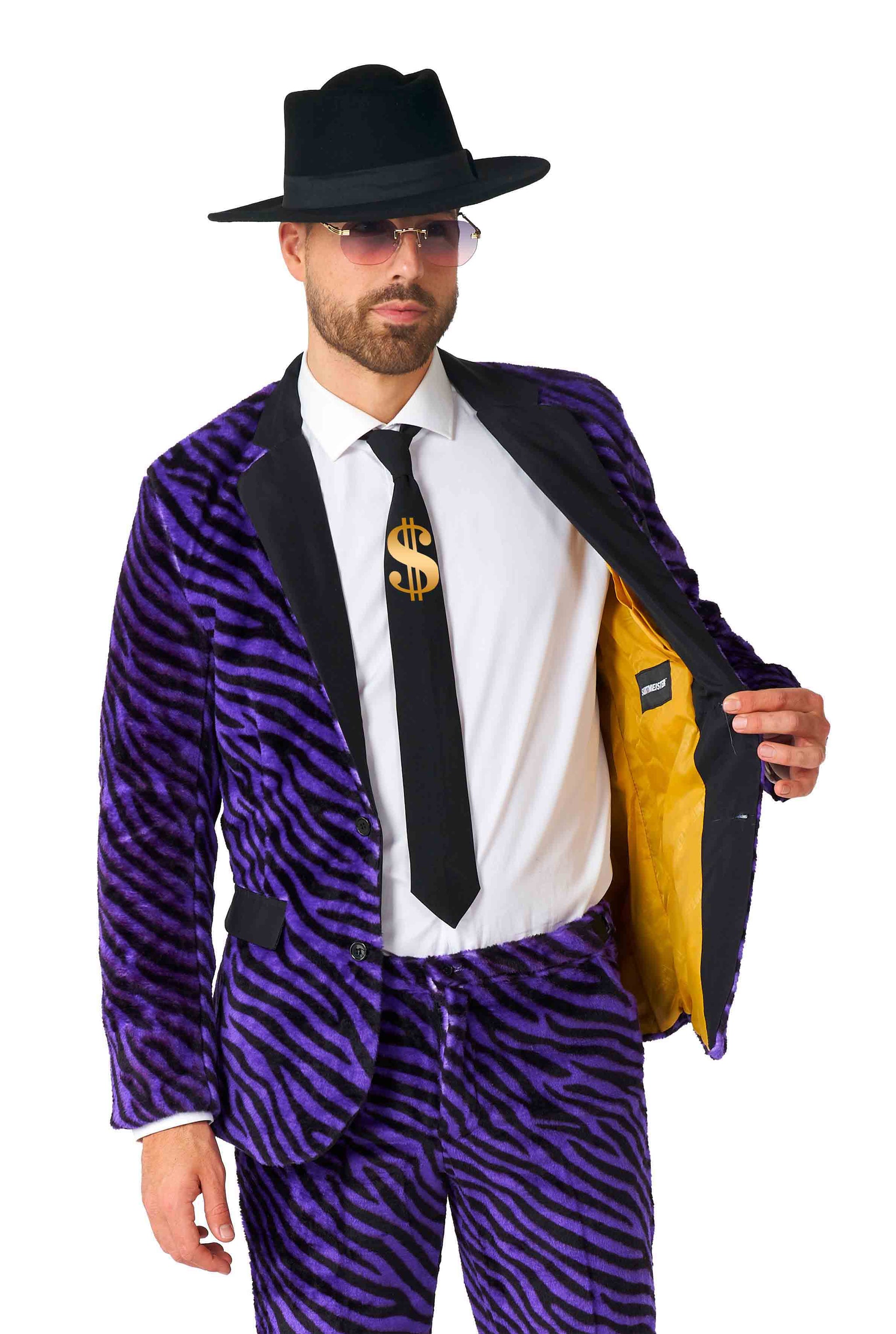 A person dressed in the Suitmeister Pimp Faux Fur Purple ensemble opens one side of their jacket to reveal a yellow lining. They are wearing a black hat, sunglasses, and matching purple zebra-patterned jacket and pants, complemented by a white shirt and a black tie featuring a gold dollar sign.