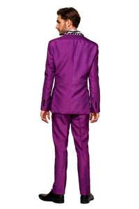 A person with short brown hair stands facing away from the camera, wearing Suitmeister's bright purple "Pimp" suit paired with a striped black and white shirt underneath. They are also wearing black shoes against a white background.