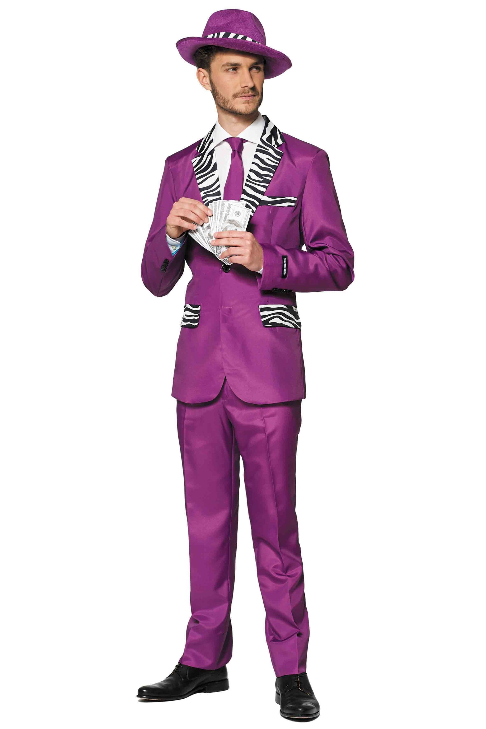 A man wearing the Suitmeister "Pimp" ensemble, a vibrant purple suit with stylish zebra print accents, stands holding a stack of money. He completes his look with a coordinating purple fedora and black shoes, along with a crisp white shirt and matching purple tie.