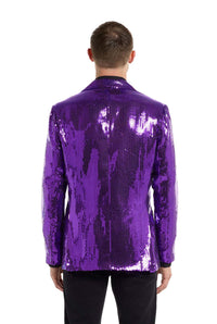 A person wearing the Suitmeister Sequins Blazer in Purple is facing away from the camera. The blazer reflects light, creating a sparkling effect. The person is also wearing black pants.