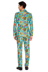 A person is dressed in the Retro Blue 90’s Icons - Carnival Suit by Suitmeister, showcasing a vibrant geometric pattern with stars, spirals, and angular shapes. The suit features a predominantly blue design with lively yellow, orange, and green accents. The individual is photographed from the back.