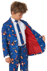 A young boy wearing the Retro Gamer Navy - Gamer suit by Suitmeister, featuring video game-themed designs, including coins and game characters. The suit jacket is open, revealing a red lining. He completes the look with a white shirt and matching tie.