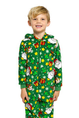 A cheerful child dressed in Suitmeister's Santa Elves Green - Christmas Onesie, showcasing a festive pattern of Santa, stars, clouds, and gifts.