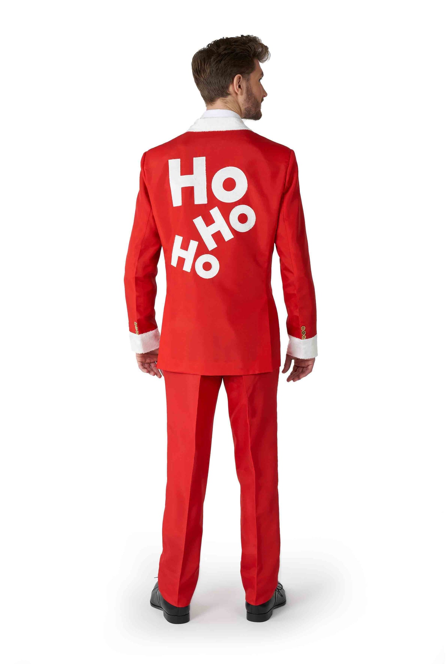 A man wearing the Santa Faux Fur - Santa Christmas suit by Suitmeister, showcasing white cuffs and large HO HO HO letters on the back, stands facing away against a white background.