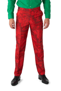 A person wearing a green shirt paired with vibrant red Scarlet Joker™ pants from Suitmeister, featuring a lively comic strip pattern with various cartoon panels. The individual completes the look with black shoes.