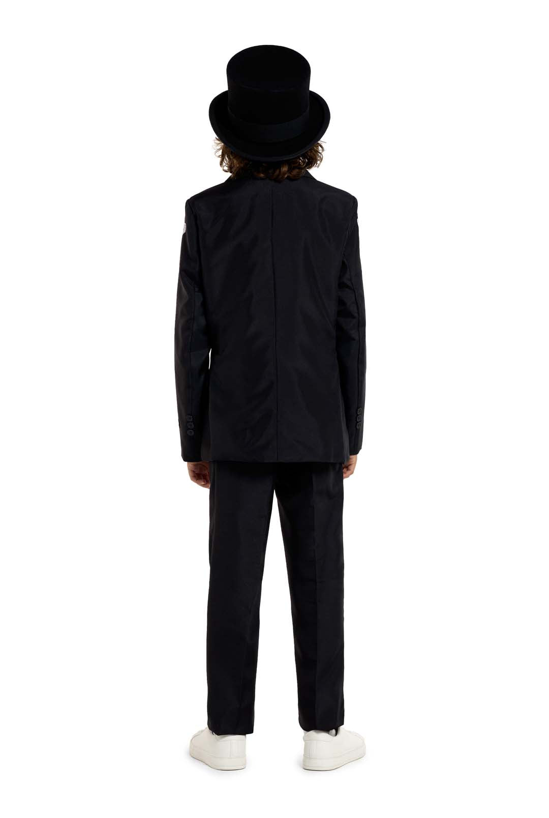 A person with shoulder-length hair is standing with their back to the viewer, wearing a Suitmeister Skeleton Grunge Black suit and a top hat. They are also sporting white sneakers against a plain white background.