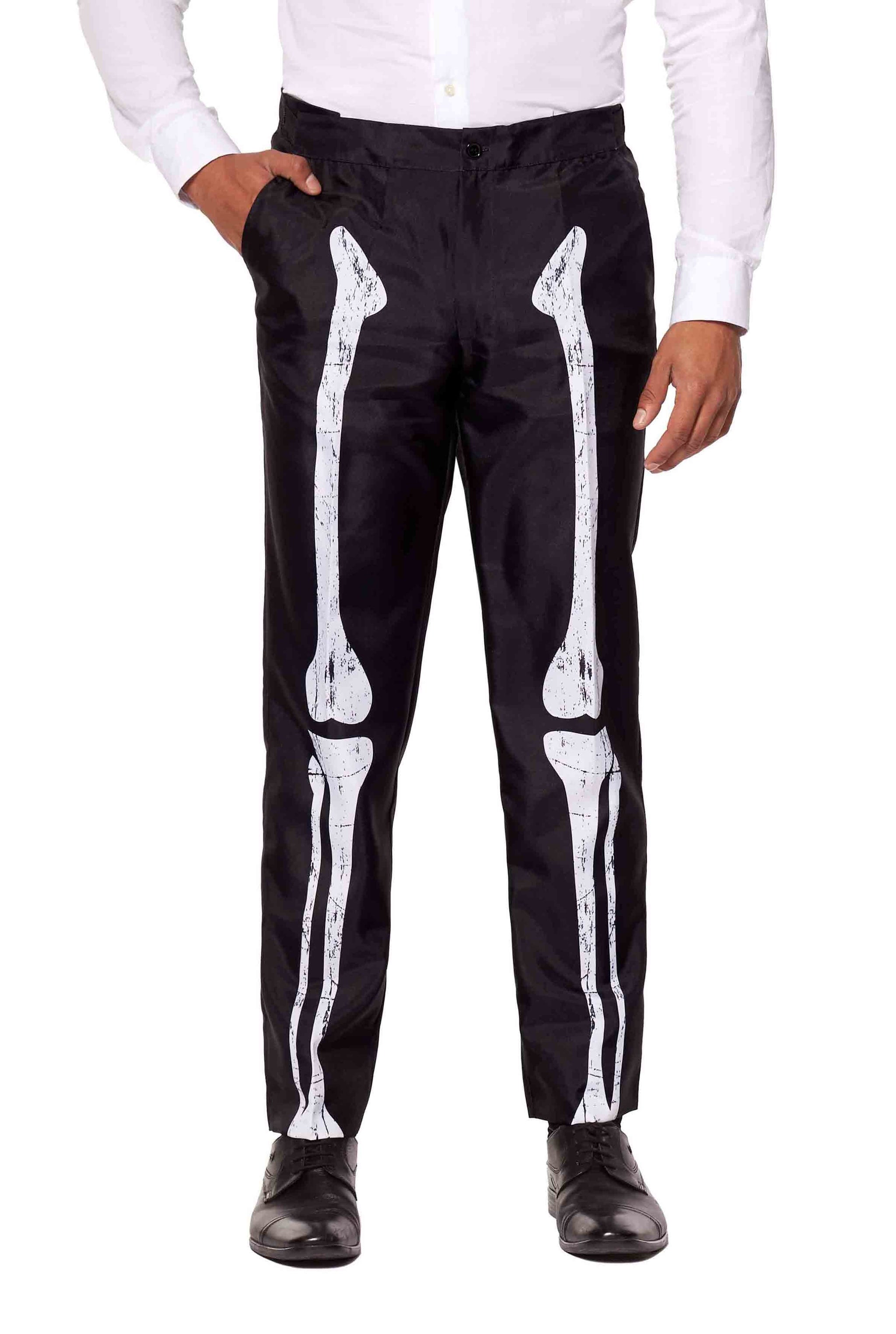 A person wearing the Suitmeister Skeleton Grunge Black pants, featuring white prints that resemble leg bones, paired with a white shirt and black shoes.