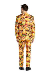 A person wearing the Suitmeister Snack Master - Carnival suit, adorned with colorful images of burgers and fries, stands with their back to the camera. They are dressed in black shoes against a plain white background.