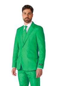 A man models the **Solid Green Suit** by **Suitmeister** against a white background. He completes the look with a white shirt and green tie, featuring a label on the sleeve of his suit.