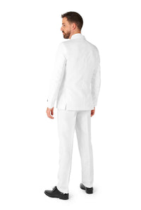 A man wearing the well-fitted Suitmeister Solid White suit and black shoes stands facing away, appearing to look to his left against a plain white background.