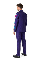 A man is seen from behind, dressed in the Suitmeister Sugar Skull Purple suit, featuring a vibrant purple color adorned with colorful floral designs on the sleeves and sides. He complements the look with black shoes against a white background.