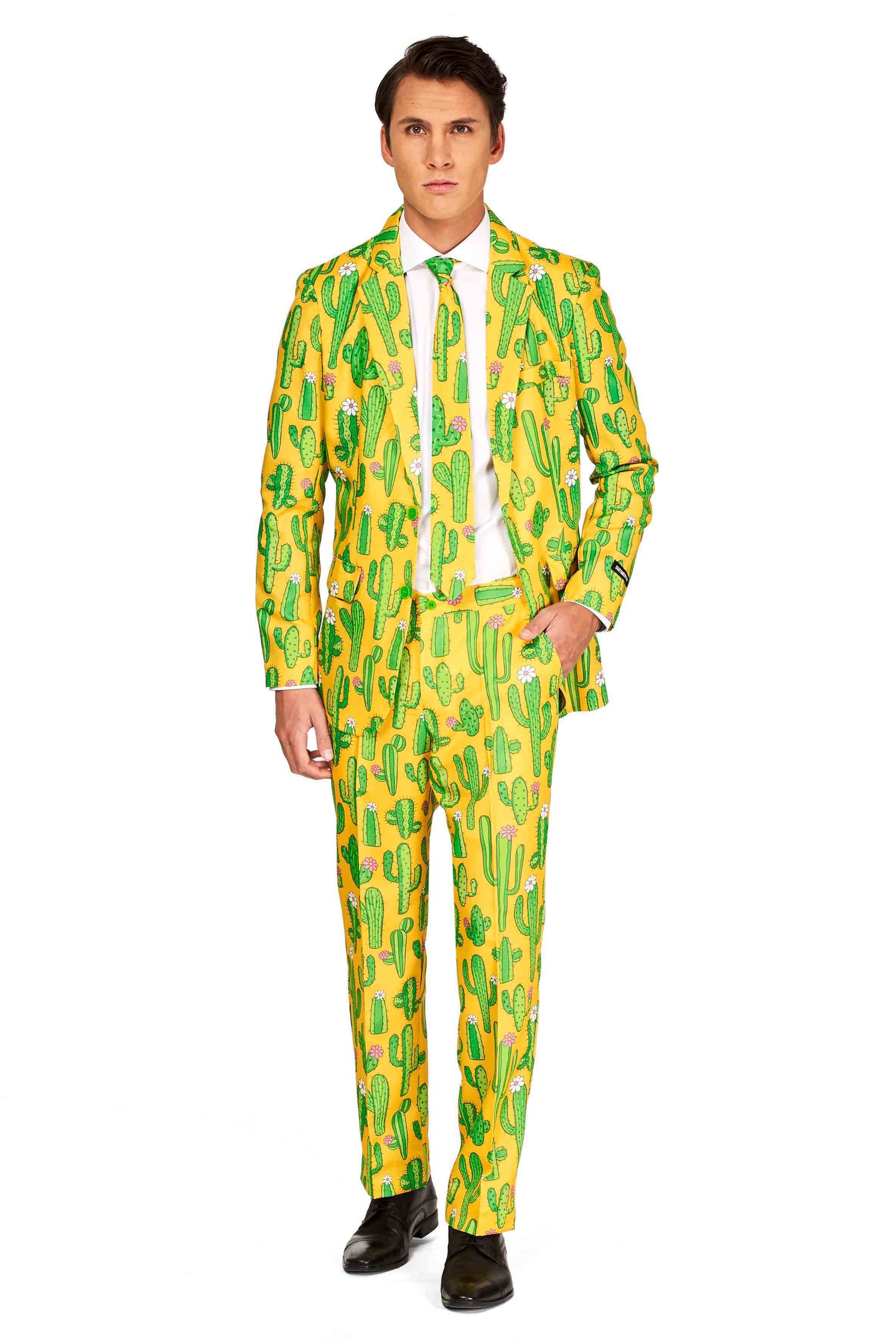 A person is dressed in the Suitmeister "Sunny Yellow Cactus - Festival Suit," featuring a bright yellow ensemble adorned with a playful green cactus pattern. The look is completed with a matching tie, a crisp white shirt, and sleek black shoes, all set against a plain white background.