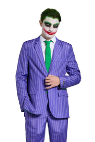 A person dressed in the Suitmeister's The Joker costume, featuring a purple pinstripe suit and a green tie, stands against a white background. Their face is painted white with black eye makeup and an exaggerated red smile, giving them the appearance of a clown.