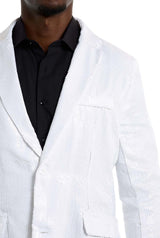 A person wearing the Sequins Blazer White by Suitmeister over a black dress shirt. The image captures the upper torso, emphasizing the texture and shine of the blazer's sequins.