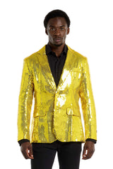 A man wearing the Suitmeister Sequins Blazer Yellow over a black shirt is standing in front of a plain white background. He has short black hair.