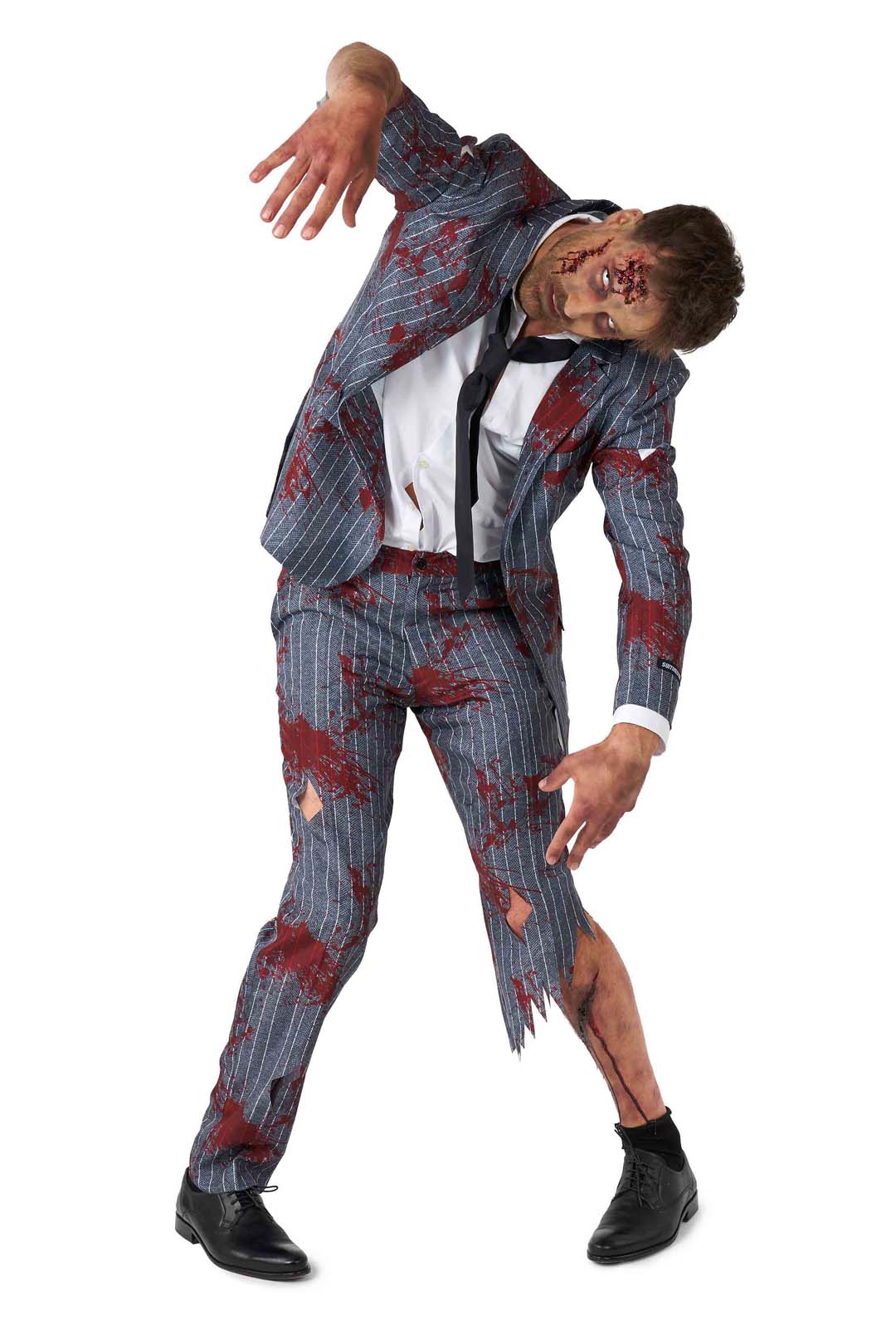 Wearing the Zombie Grey costume from Suitmeister, this person resembles a terrifying zombie in a distressed, blood-stained pinstripe suit. Their fake blood-smeared face and shirt add to the eerie effect as they lean forward with arms bent and a menacing expression, all set against a white background.